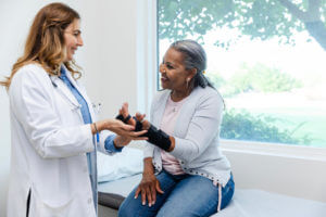 female patient smiles while talking to her orthopedic surgeon