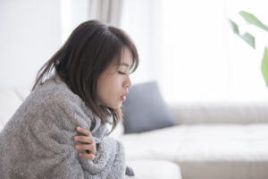 A Woman is sick and down with cold and flu.